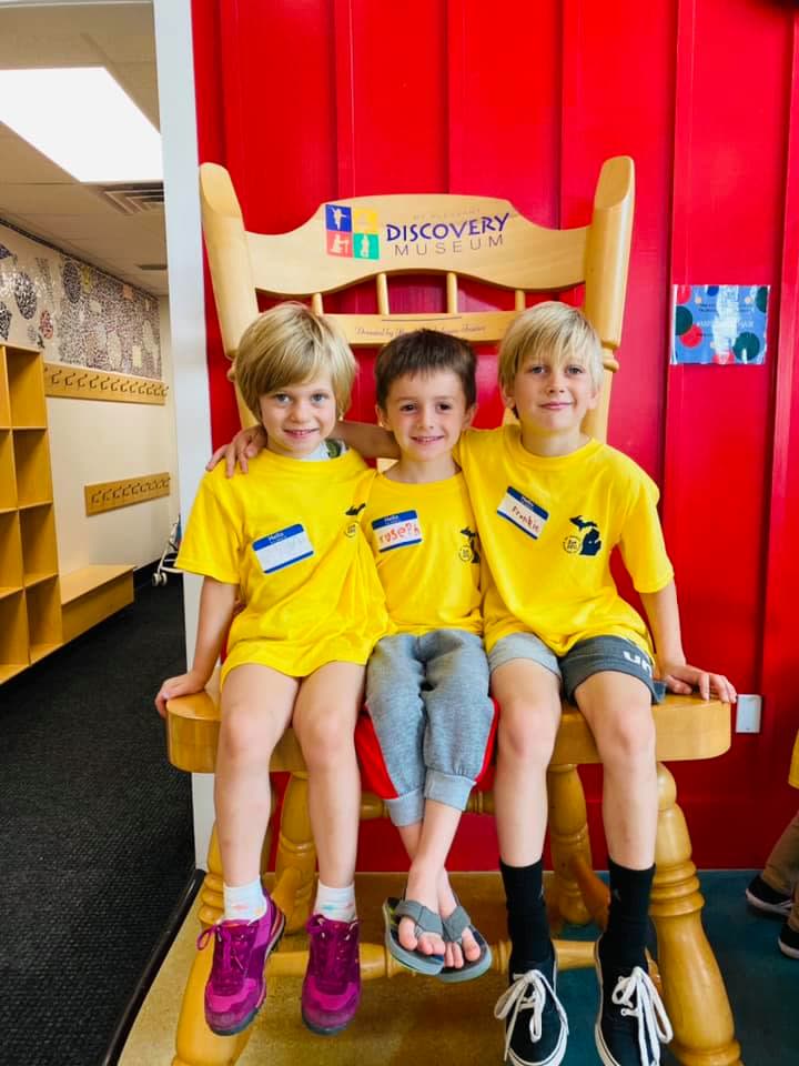 Kids on the giant museum chair
