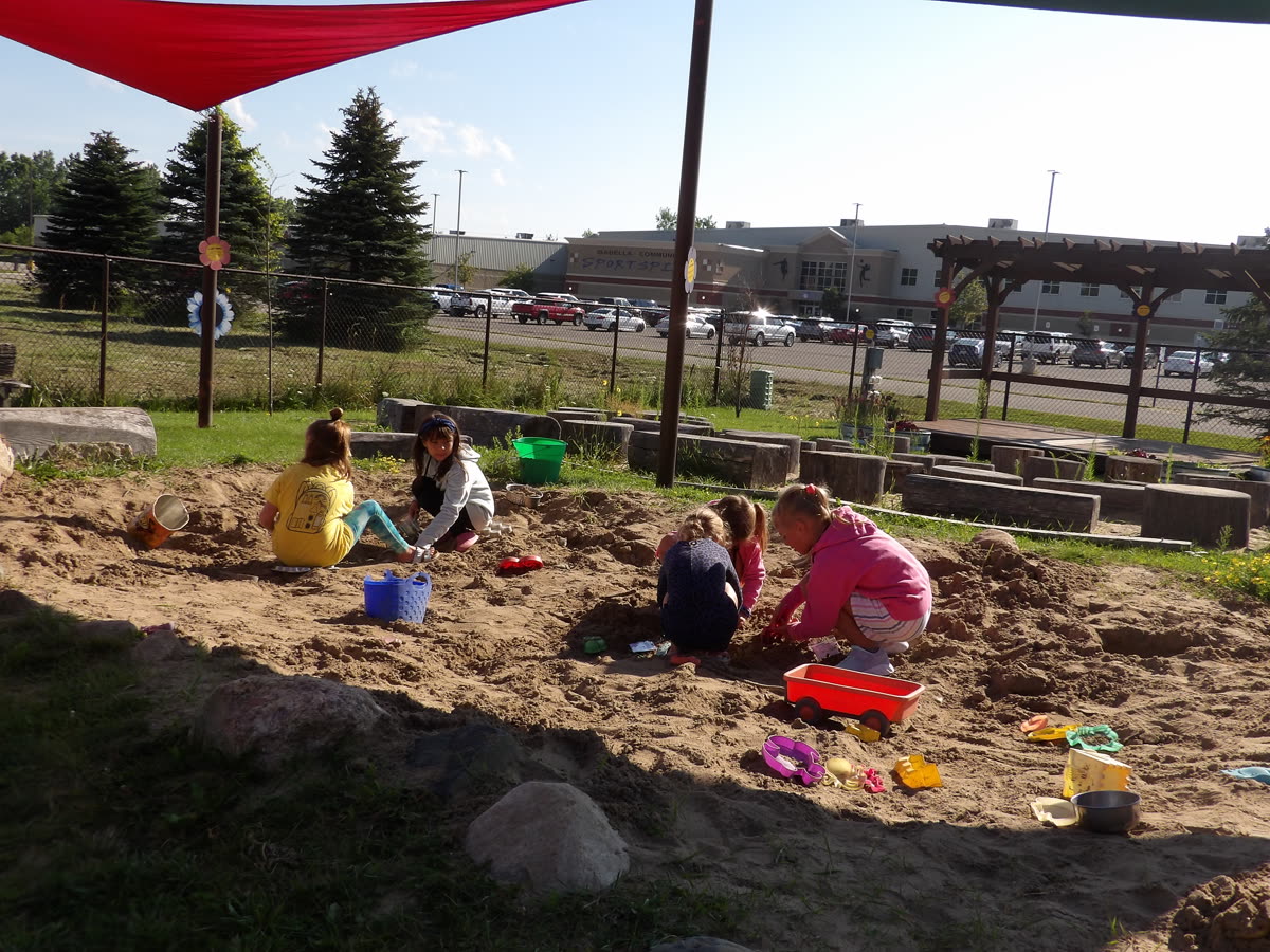 Children digging at the outdoor dino dig
