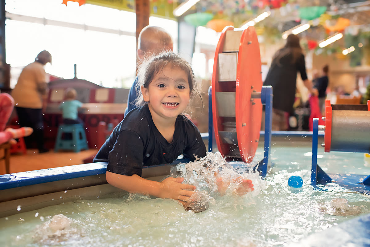 A child splashing at the Water Works exhibit