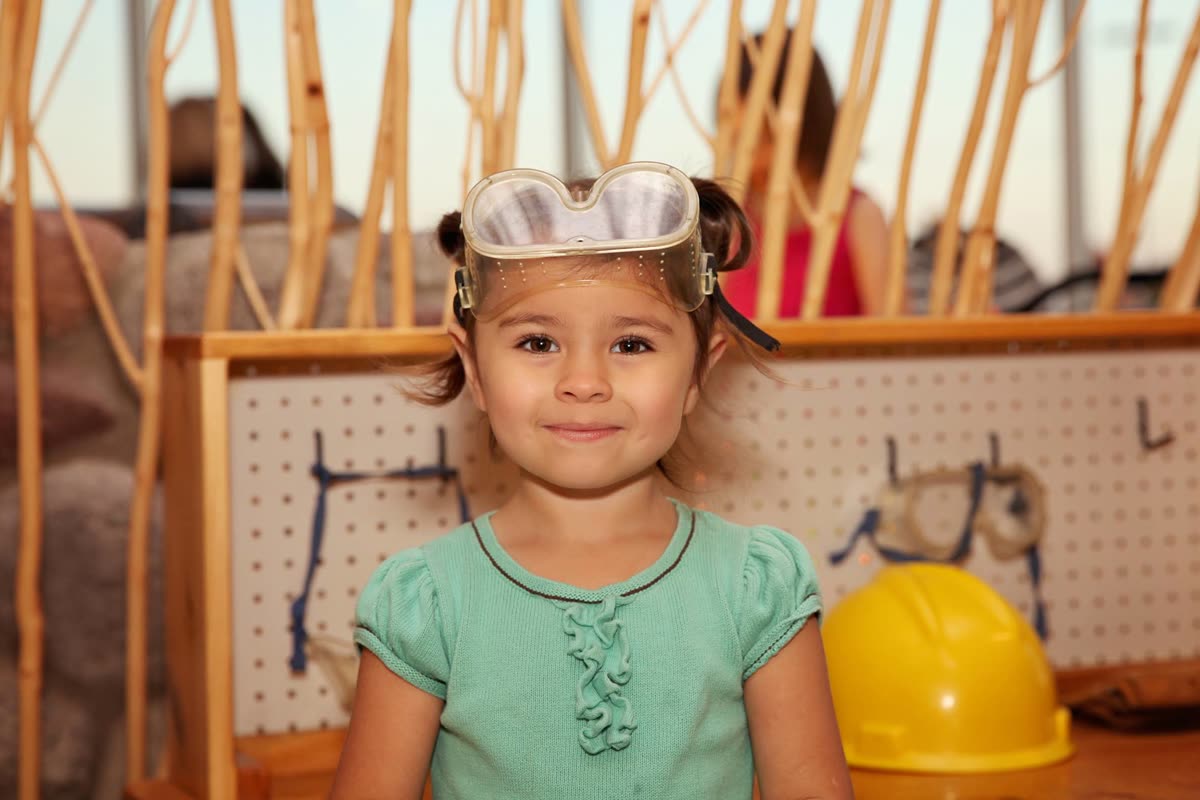 A young builder hard at work at the woodworking bench